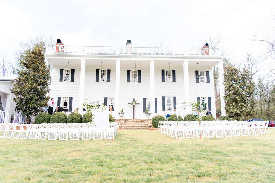 A wedding ceremony set up on the lawn of a Love and Lavender venue