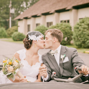 bride and groom in DIY roadster
