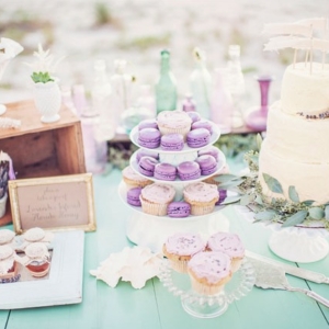 lavender macaroons and acake on mint color dessert table cloth