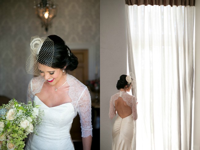 Bride wearing elegant white sheath wedding dress with lace bolero featuring 3/4 sleeves in ballroom