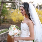 4 Bride wering wedding dress with sweet heart neckline and headband hold pink green and white bouquet and a figertip length veil