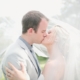 bride-and-groom-kissing-uv nder-wedding-veil