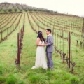 24 bride and groom standing in vinyard at Livernano Radda in Chianti Tuscany, Italy