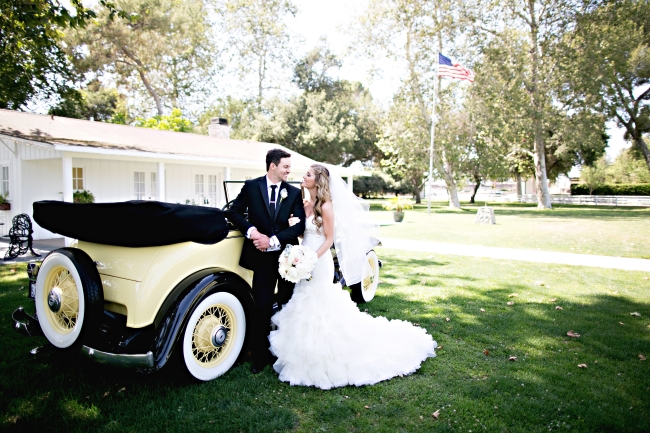 cream colored classic 1932 Chevy convertible with bride and groom