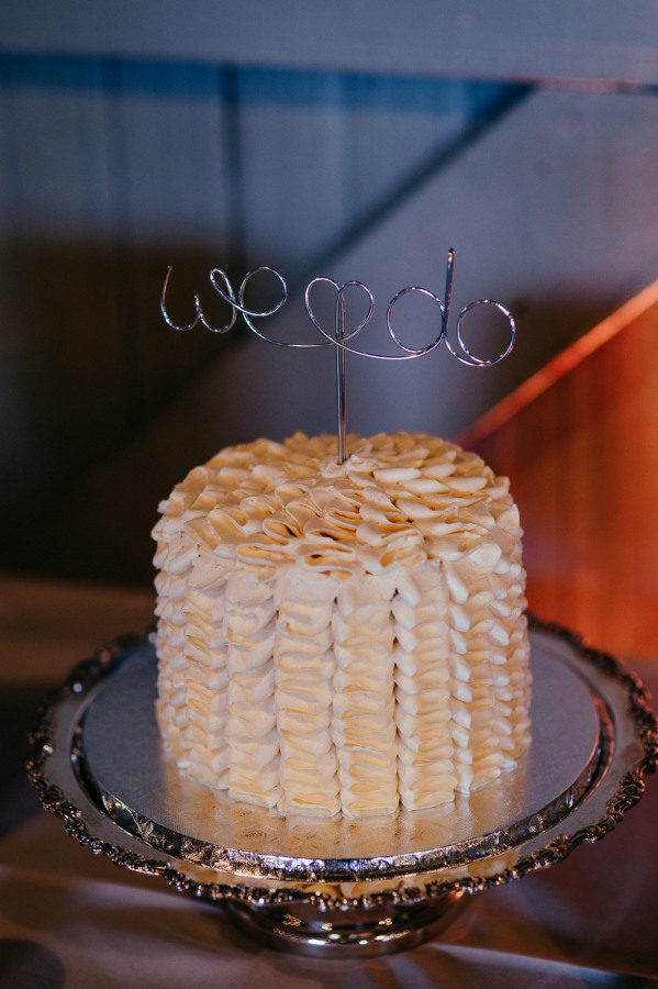 Silver wire cake topper spelling we do with a heart on a single-tier white cake