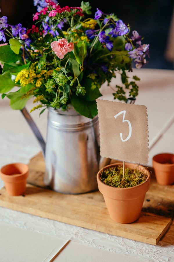 14. Wedding reception centerpiece using tin watering can and terracotta pots