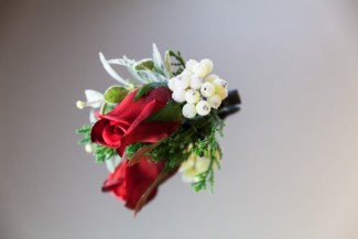 Red rose boutonniere with white hypercum berries 