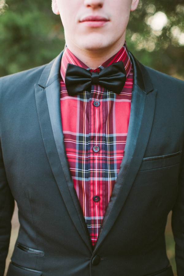 Groom wearing plaid shirt and black bow tie 