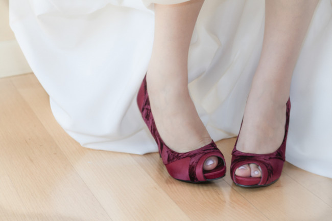 Bride wearing red peep toe pumps