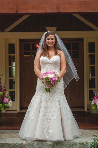 Bride wearing strapless mermaid wedding dress with lace and tulle detailing at outdoor backyard wedding