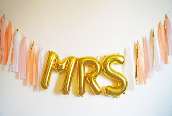 Gold foil balloons spelling out MRS
