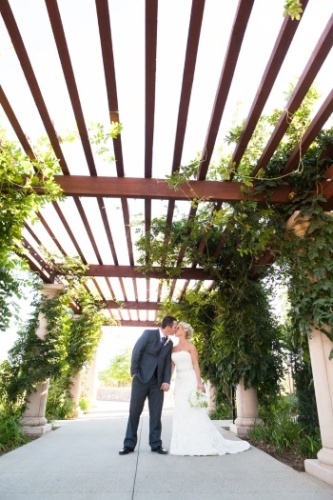 bride-and-groom-kiss-under-trelace