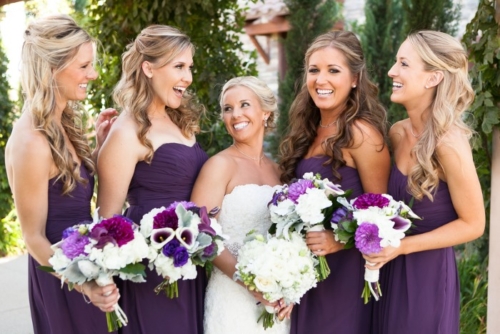 bridesmaids-in-dark-purple-dresses-hold-bouquets