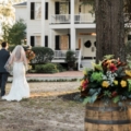 newlyweds walk towards plantation house