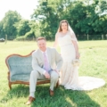 couple pose on vintage sofa outdoors