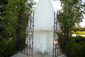 gown hanging at gates of winery