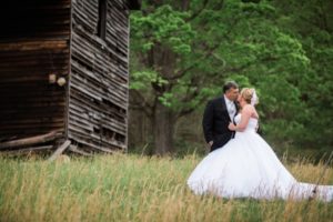 newlyweds near old wood shed