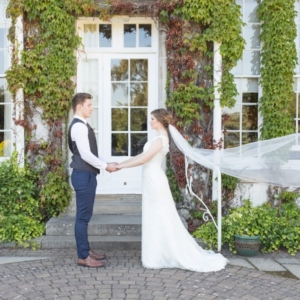 bride’s veil blowing in front of Rufflets Hotel