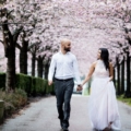 cherry blossom engagement shoot couple walk on Vancouver sidewalk