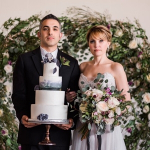 holding cake and bouquet