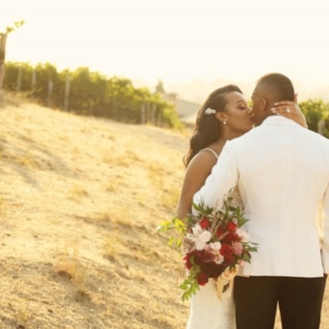 newlyweds among vines at Meritage vineyard