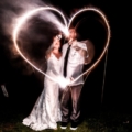 newlyweds make heart from sparklers