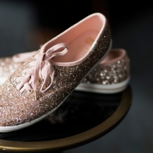 keds shoes on side table