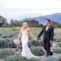 newlyweds walk in lavender field