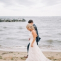 newlyweds walk on beach in Maryland