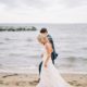 newlyweds walk on beach in Maryland