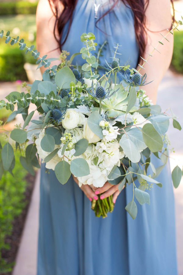 Wildflower bouquet with silver dollar eucalyptus, white ranunculus, hydrangea, blue thistle, and succulent