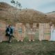 newlyweds play on giant LOVE wood sign