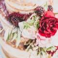real blackberries and flowers adorn cake