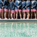 groomsmen lined up in red striped trunks with blazers