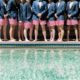 groomsmen lined up in red striped trunks with blazers
