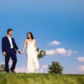 newlyweds with blue sky backdrop