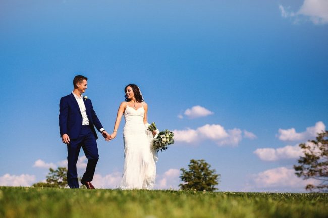 newlyweds with blue sky backdrop