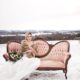 styled-fur-bride-on-vintage-couch-outdoors-in-field