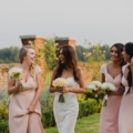 bridesmaids-and-bride-walk-in-garden