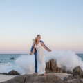 Los Cabos newlyweds on spalshing rocks