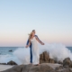 Los Cabos newlyweds on spalshing rocks
