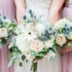 bouquets with blue thistle and cream roses