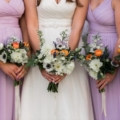 bridesmaids in lilac dresses with bouquets