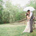 couple kiss under white umbrella