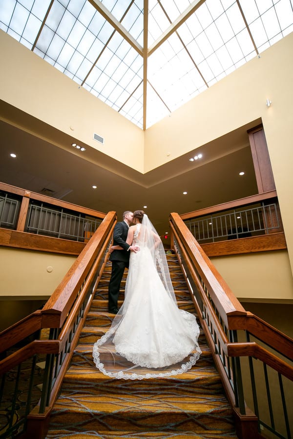 bride-groom-kiss-on-stairs-posed-portraits