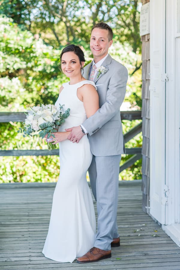Newlyweds posed portrait at Long Beach Island showing ruffle shoulder detail