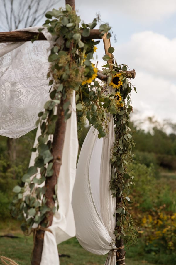 wedding-venue-decor-detail-cermony-arch-wooden-fabric-sunflowers