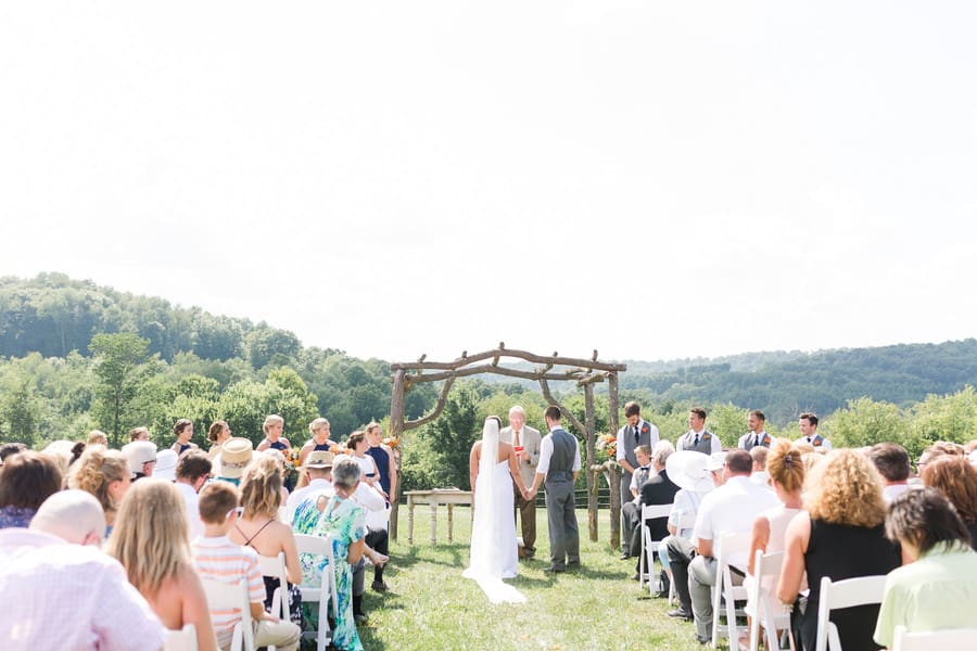 wedding-ceremony-portrait-bride-groom-celebrants-wooden-arch-rivercrest-farm