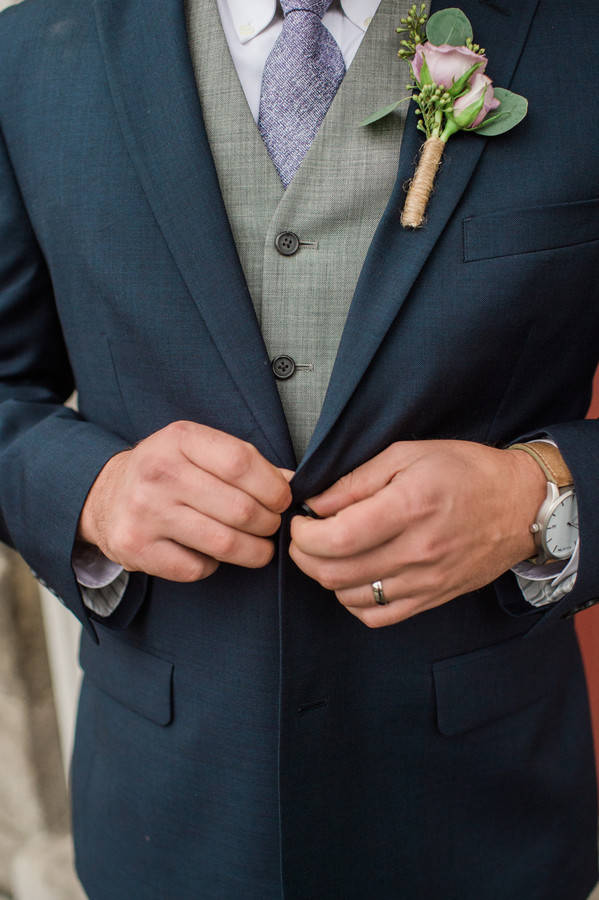 groom-close-up-grey-waistcoast-navy-suit-rose-boutineer