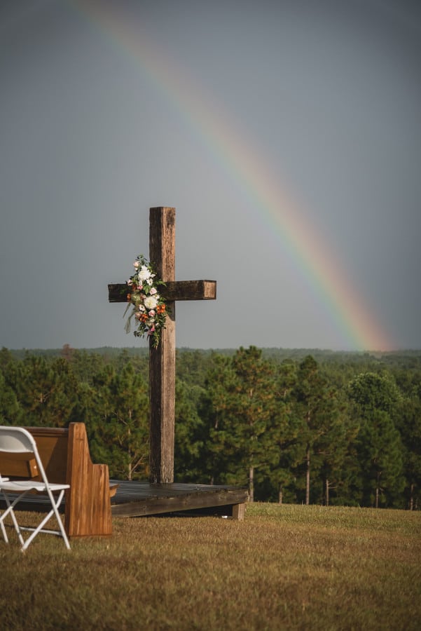 wedding-ceremony-venue-wooden-cross-rainbow